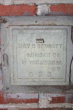 Click image to enlarge: Bennett iron name plate in basement.