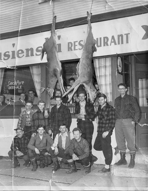 Back at the tavern after deer hunting. Owner John Strusienski (3rd from the left) and above him (in the window) is Julia Ma Strusienski.